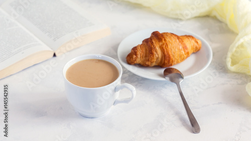 Cup of coffee and croissants on white background. Morning breakfast