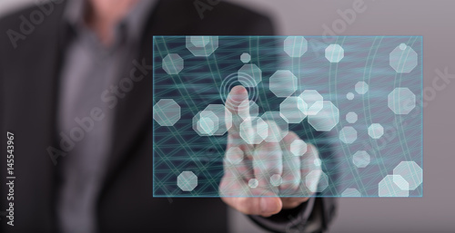 Man touching an abstract network concept on a touch screen