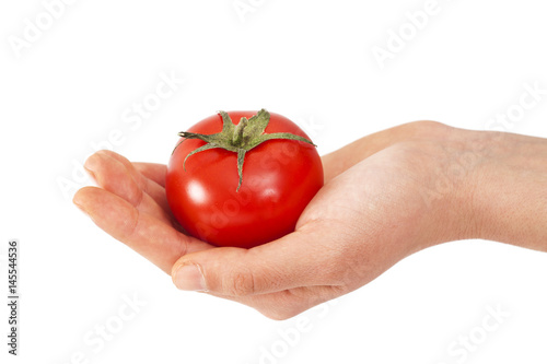 Woman hand holding tomato