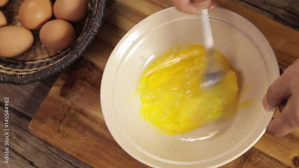 Eggs - Mixing 2 Brown Eggs In White Bowl - Top Angle 2 Eggs - Mixing 2 Brown Eggs In White Bowl - Top Angle 2