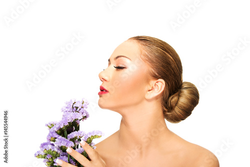 Sensual young spa woman holding flower.