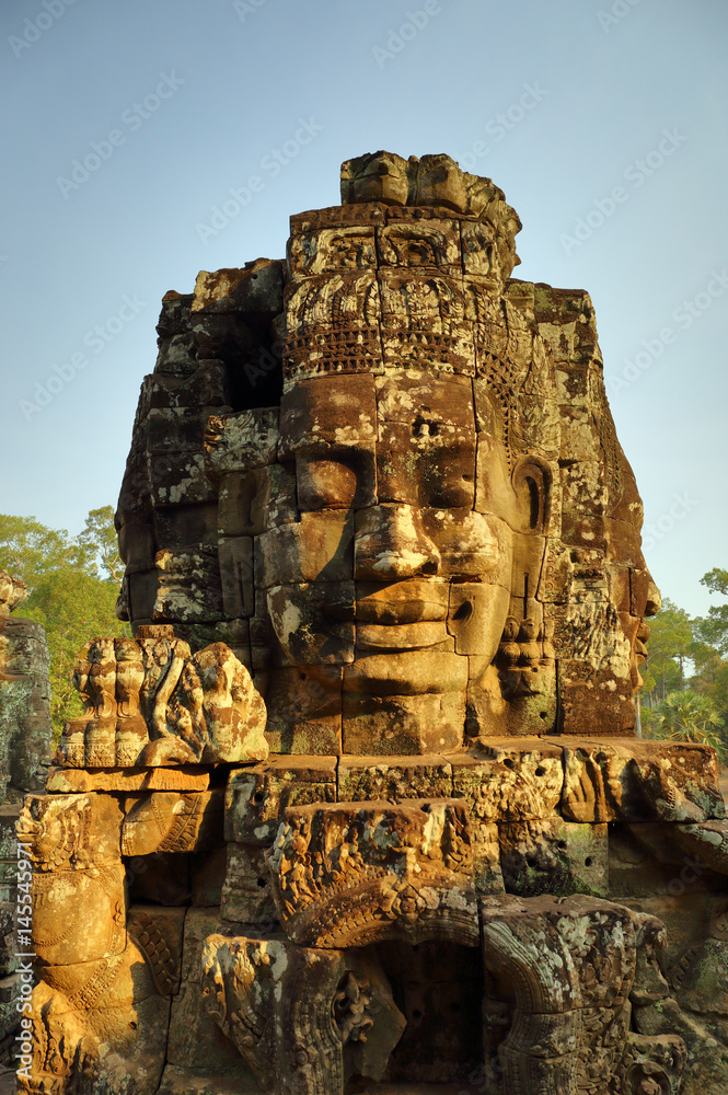 Fototapeta premium Giant stone faces at Bayon Temple in Cambodia