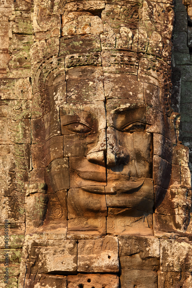 Giant stone face at Bayon Temple in Cambodia Giant stone face at Bayon Temple in Cambodia