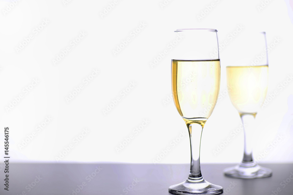 glass of white wine on a table on white background isolate