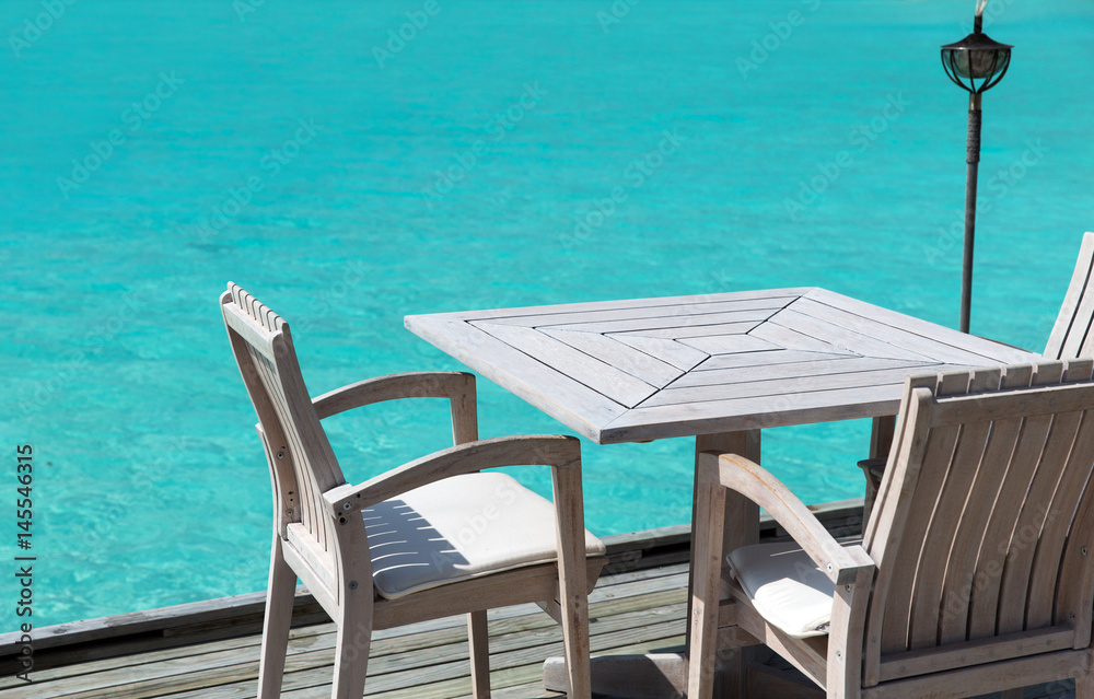 table and chairs at restaurant terrace over sea