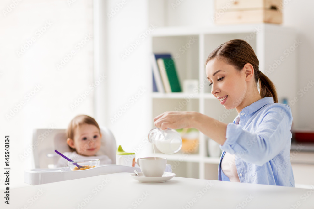 happy mother and baby having breakfast at home happy mother and baby having breakfast at home