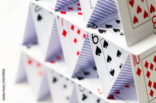 house of playing cards over white background