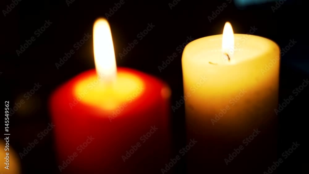 Three candles on table in empty dark room Three candles on table in empty dark room