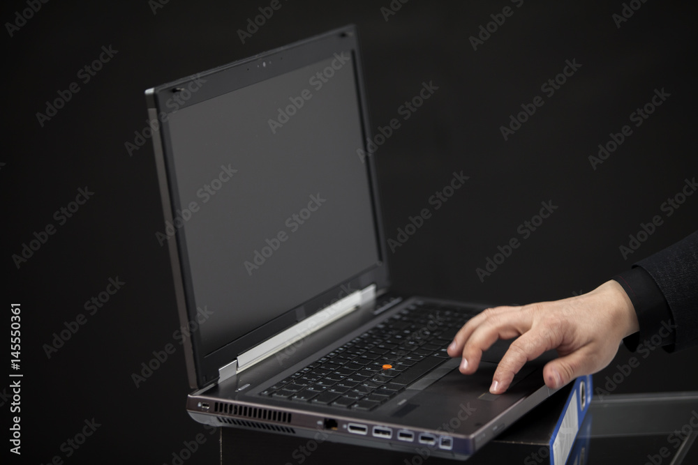 An employee is typing on the keyboard of the computer. An employee is typing on the keyboard of the computer.