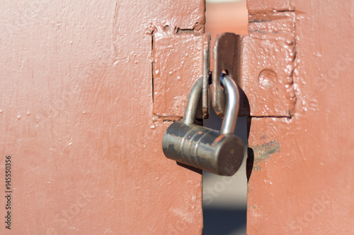 Lock on brown metal gate, closeup
