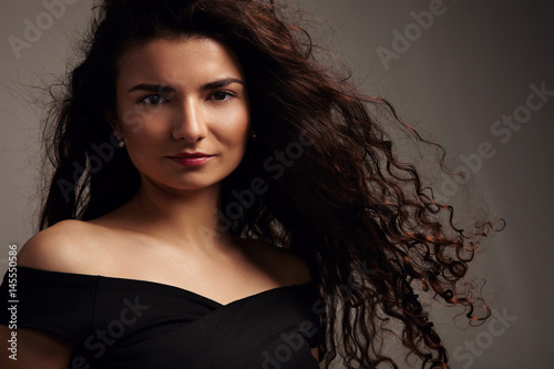 pretty smiling young model with ideal skin and curly hair