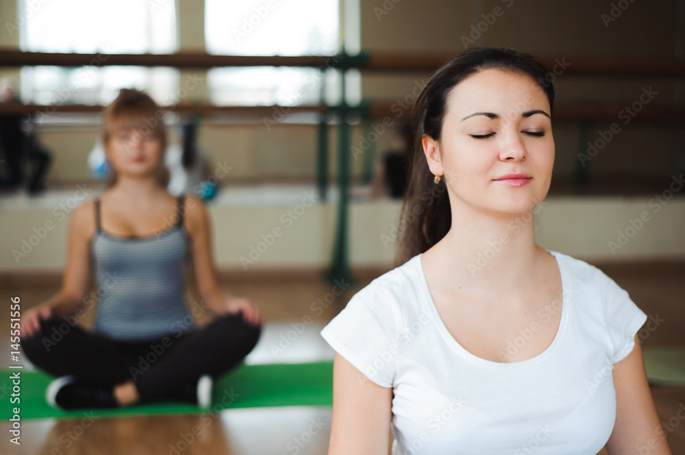 athletic woman doing relaxation exercises in gym class athletic woman doing relaxation exercises in gym class