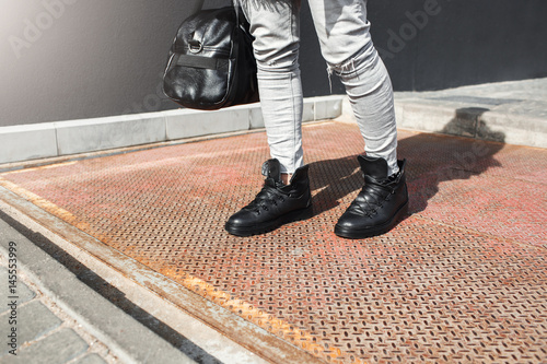 Cropped image of man feet in fashion leather boots.