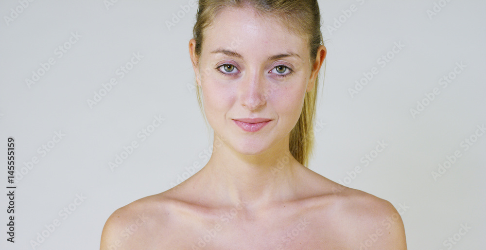 Portrait of a beautiful young girl smiling and looking at the camera ...