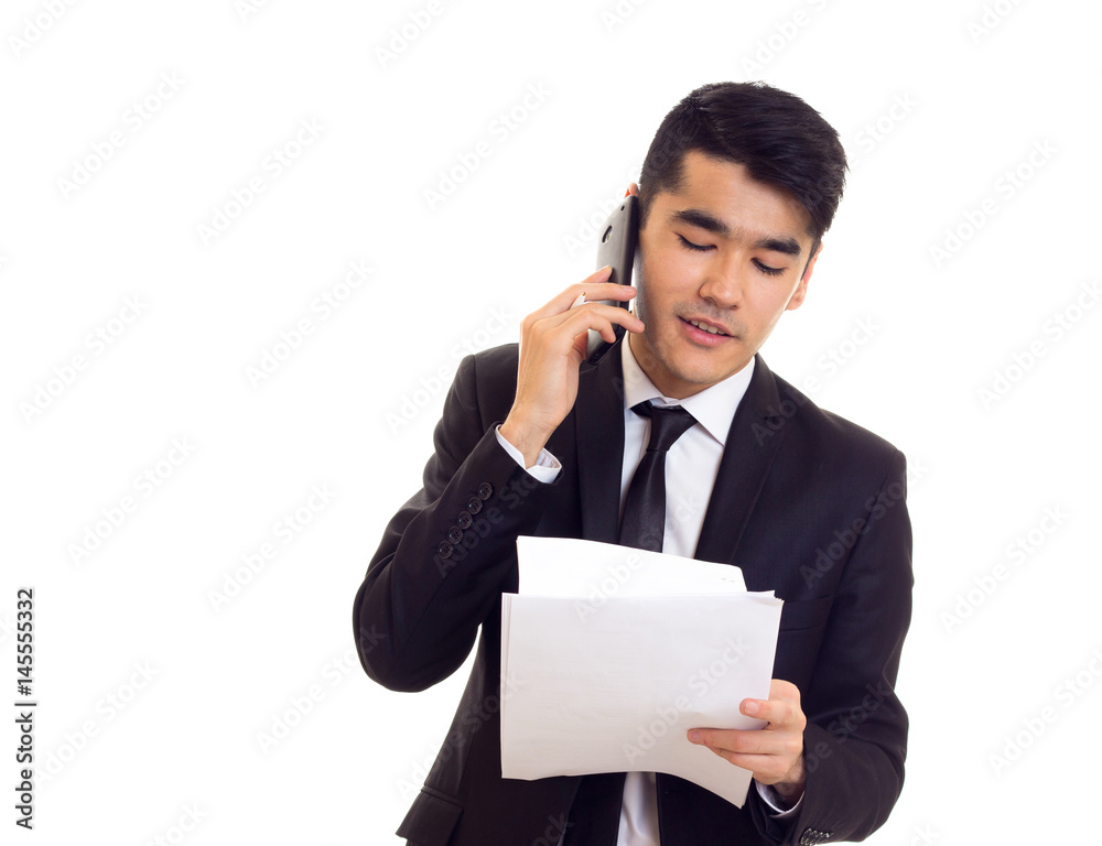 Young man in suit holding papers Young man in suit holding papers
