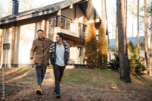 Happy friends walking outdoors in the forest