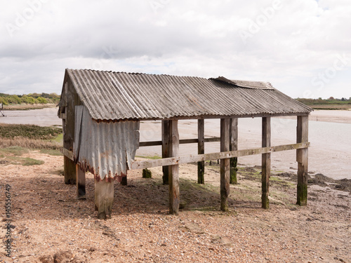 an old and abandoned sea shack shed decaying and rotting © Callum