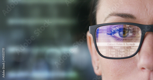 The future business girl looks into the hologram, monitors trade, finances, volition, sales and purchases,in the office.Concept:career growth,business affairs,future savings,logistics,broker,marketing photo