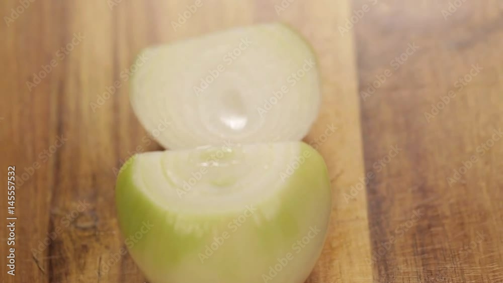 White Onions - Chopping White Onion With A Knnife - Side Angle White Onions - Chopping White Onion With A Knnife - Side Angle