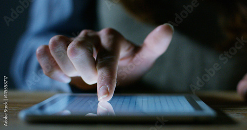 Fotografie hand typing and touch a screen LCD and interacts with applications and finance and mathematical charts