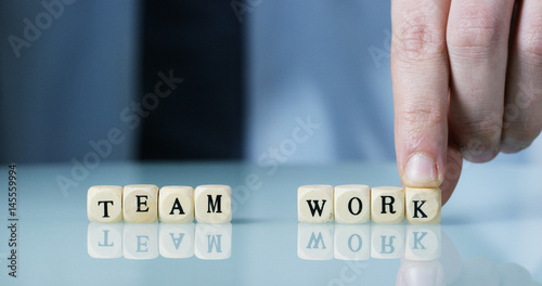 Young businessman hand creates the word 