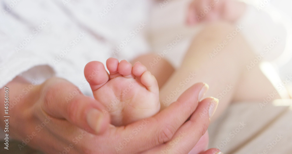 A cute little baby is looking into the camera and is wearing a white stripe with flower, The baby looks around and start crying A cute little baby is looking into the camera and is wearing a white stripe with flower, The baby looks around and start crying