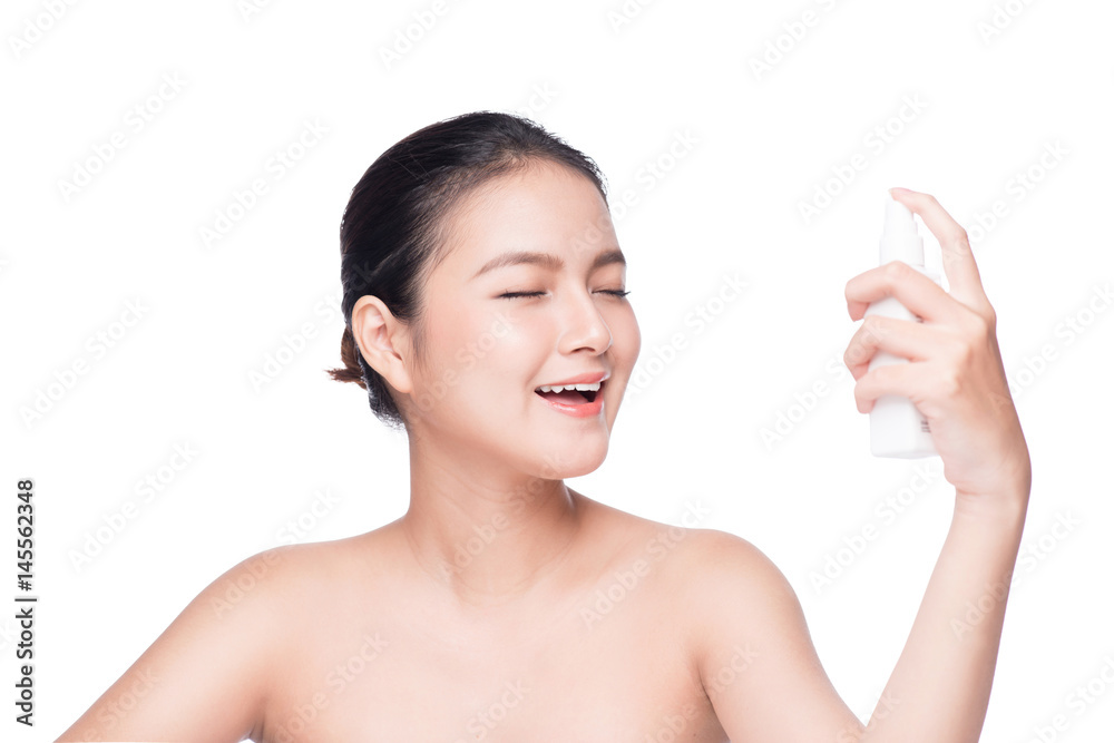Beautiful asian woman applying spray water on face isolated white background. Beautiful asian woman applying spray water on face isolated white background.