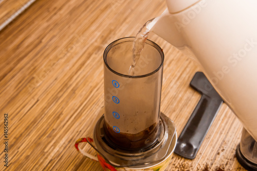 Preparation of ground coffee in aeropress - portable filter coffee maker © Alexandr