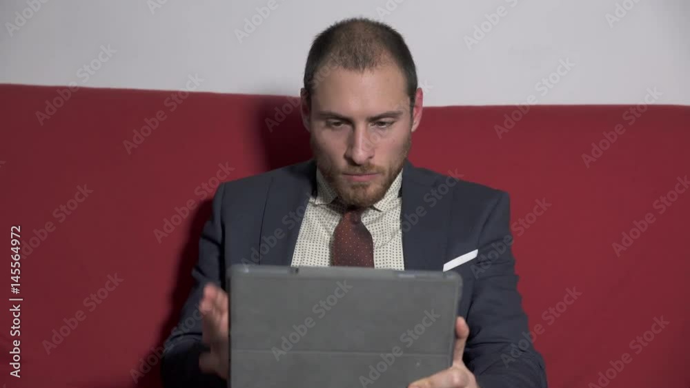 Businessman talking with a partner through the tablet Businessman talking with a partner through the tablet