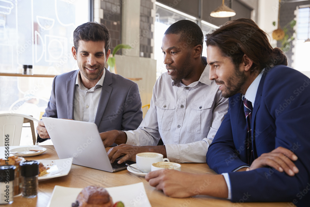 Three Businessmen Having Meeting In Coffee Shop Three Businessmen Having Meeting In Coffee Shop