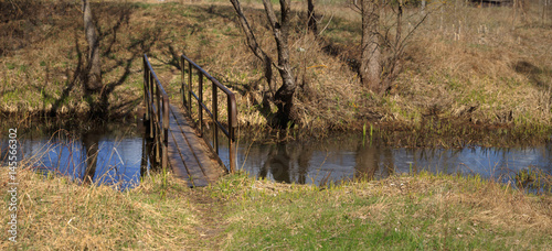 Spring landscape bridge over a small stream photo