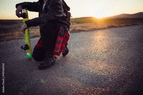 Man relaxing on the street with skateboard