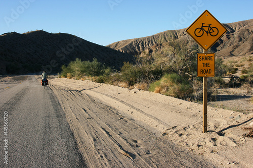 Long distance cycling supported by kind road signs, Near Mecca, California, USA