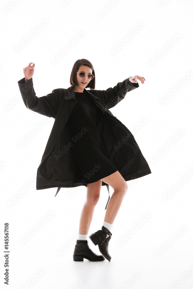 Pretty young lady wearing sunglasses posing isolated Pretty young lady wearing sunglasses posing isolated