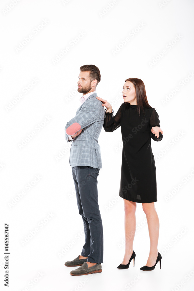 Offended young loving couple swear isolated Offended young loving couple swear isolated