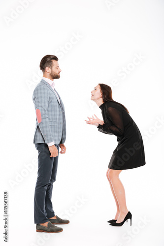 Offended young loving couple swear isolated