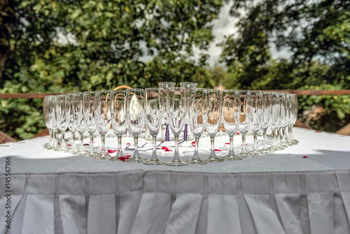 Wedding table decoration. Heart-shaped arranged champagne glasses.