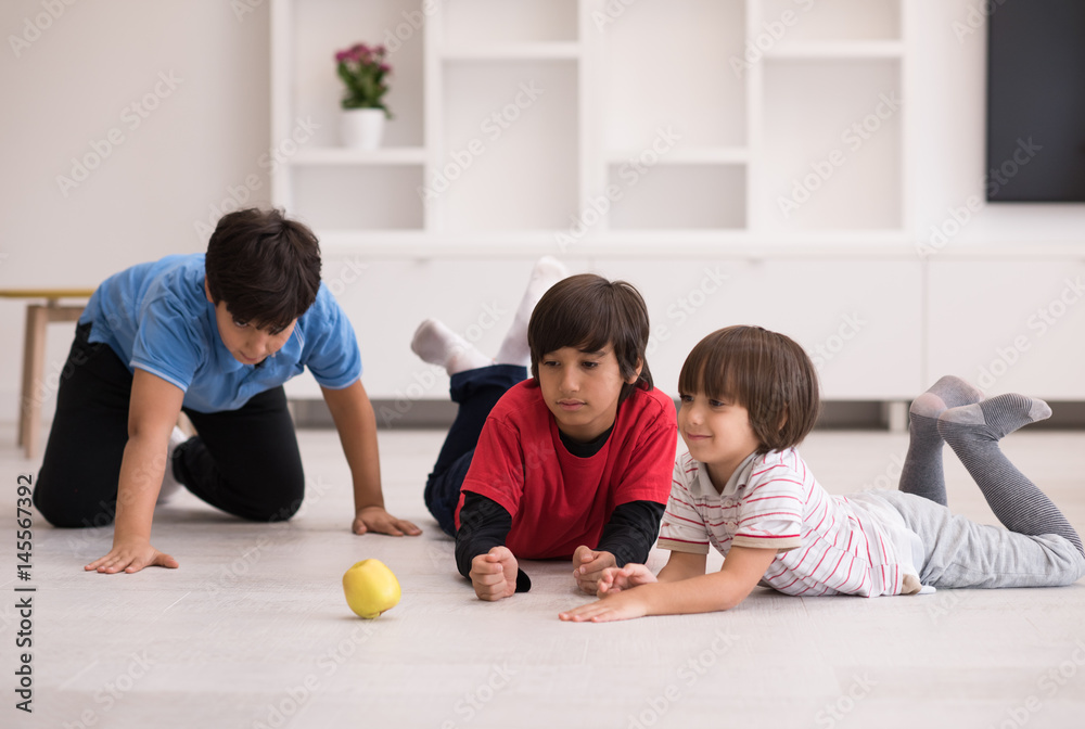 Fototapeta premium boys having fun with an apple on the floor