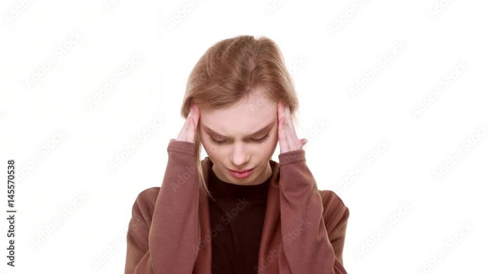 Beautiful teenager Caucasian girl standing on white background with terrible headache massaging temples Beautiful teenager Caucasian girl standing on white background with terrible headache massaging temples