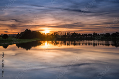 Sunset at Whittle Dene Reservoir / Whittle Dene Reservoir in Northumberland is a popular place for fishing, seen here as the sun goes down, reflecting the sky © drhfoto