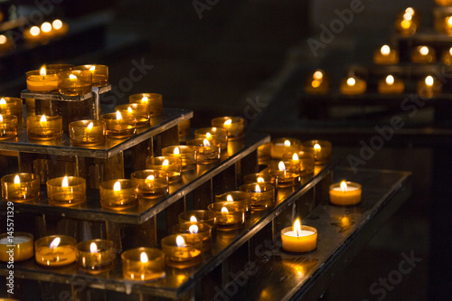 Many burning candles with shallow depth of field.