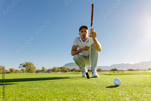 Golfer study the green before putting shot