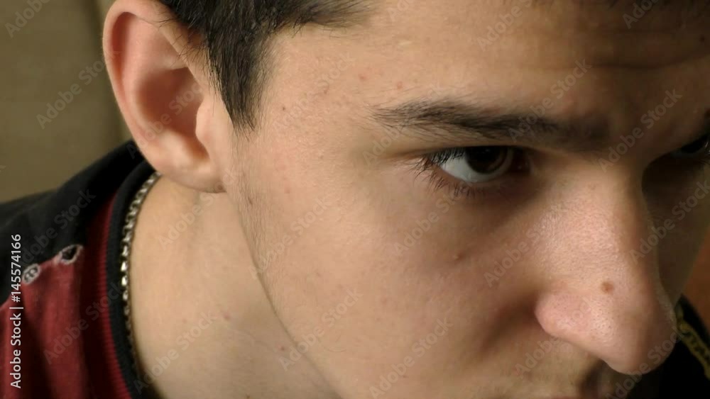 Young man looks closely at the monitor while playing a computer game. Close-up. 50 fps Young man looks closely at the monitor while playing a computer game. Close-up. 50 fps