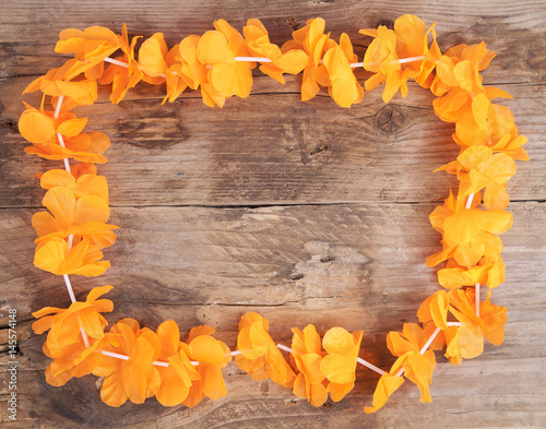Dutch orange flower necklace on wooden background