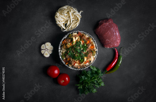 Traditional asian noodle lagman with vegetables and meat