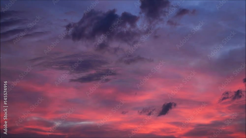 Clouds with orange, purple and black colors at sunset sky. 