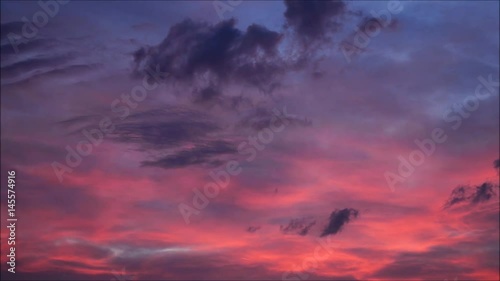 Clouds with orange, purple and black colors at sunset sky.  photo