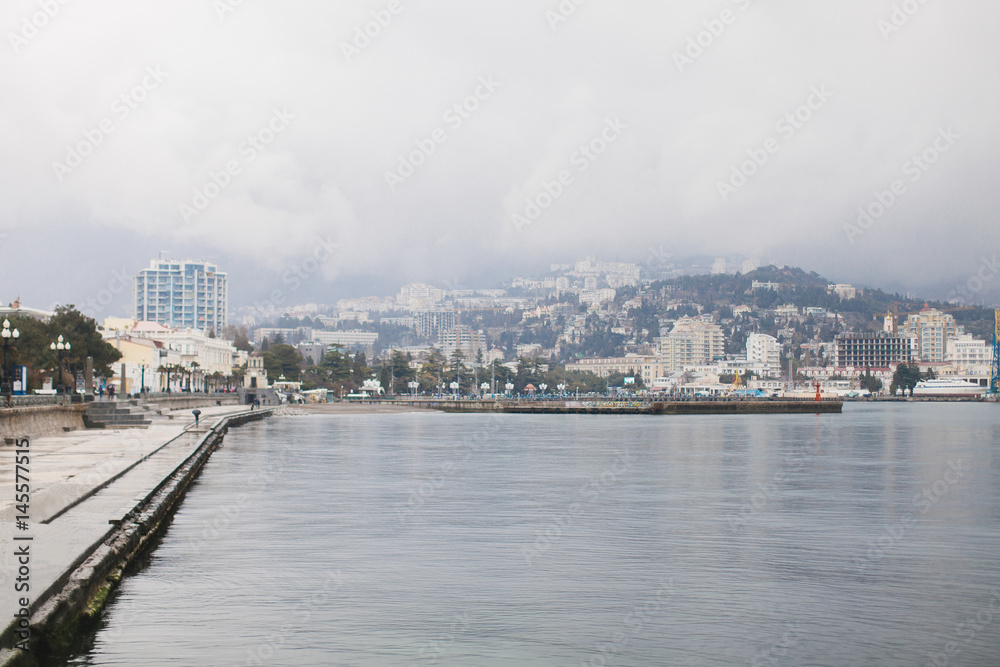 The promenade of Yalta. The port in the black sea. Cloudy weather on the black sea. The City Of Yalta- Crimea
