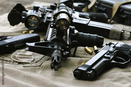 Weapons and military equipment for army, Assault rifle gun (M4A1) and pistol on camouflage background.