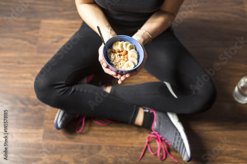 Fotografie Fitness woman with oatmeal porridge